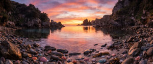 A Serene and Magical Cinematic Wallpaper of a Cove at Sunset