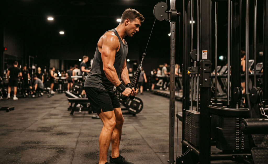 Caucasian Male Cable Triceps Pushdown GYM Workout Wallpaper