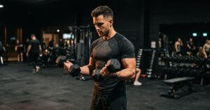 Caucasian Male Dumbbell Biceps Curl GYM Workout Wallpaper