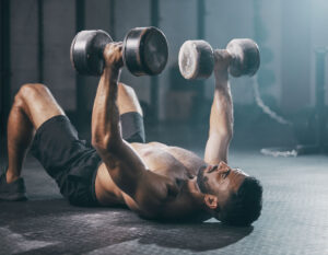 Latino Male Heavy Floor Dumbbell Press GYM Workout Wallpaper